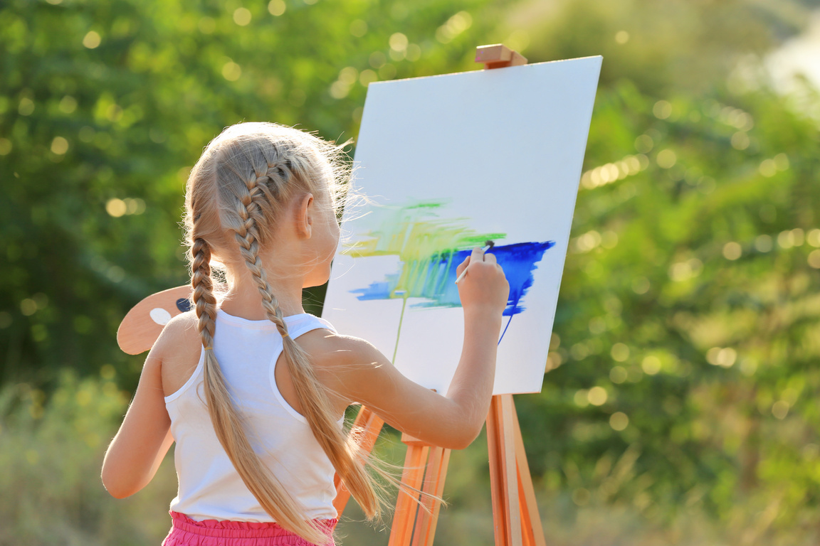 Little Girl Painting a Picture Outdoors